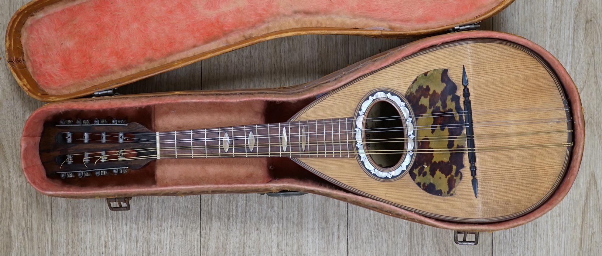 A cased Italian mandolin, labelled Domenico Maratea, and Fratelli Vinaccia, Naples, bowl backed body, length of body 30cm, with some packeted spare strings